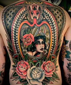 the back of a woman's body with tattoos and roses on her chest,