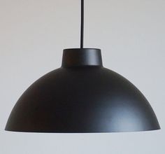 a large black light hanging from a ceiling