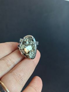 This ring is made from scratch from recycled sterling silver.  One by one the metal has been marked, creating a band with a deep hand applied texture.  The inside is completely smooth and comfortable and this darkened finish, is one of my favorites, it makes the texture pop! The stone is a natural piece of rough pyrite set in a polished bezel,  when I was choosing stones I saw these, and I truly fell for them, they are little parts of the rock, as it forms, so many little details. They had larger pieces of the walls from the mine, and you can see the different formations, this piece shows just the beginning of what over time and pressure become larger pieces. I traveled to get my stones straight from the source and to see the faces of the people who cut , polish and find them and make a li Ring Gift Ideas, Pyrite Ring, Rock Rings, Special Ring, Jewelry Boho, Recycled Sterling Silver, Wide Bands, Gorgeous Necklaces, Cultured Pearls