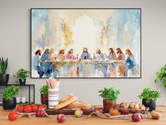 a painting hanging above a table filled with fruit and vegetables