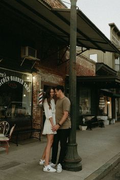 a man and woman standing under a street light