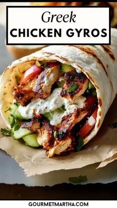 a chicken gyro wrap with lettuce, cucumber and tomatoes