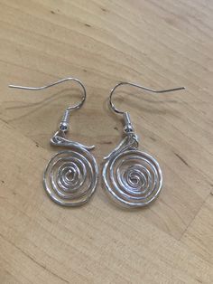 Handcrafted earrings.  Beautiful silver planished spiral earrings.  Unique design.  Sterling silver hooks.  Classy earrings!  Add some sparkle!  Size 20 mm drop. They make a lovely gift for that special person, or, why not treat yourself. Beautifully gift wrapped. Posted in a protective envelope. Free first class delivery within the UK. Returns and exchanges accepted within 3 days and returned within 7 days.  Exceptions may apply. Thank you for your interest and please look out for new designs. Classy Earrings, Spiral Earrings, Handcrafted Earrings, Special Person, Jewelry Inspo, Lovely Gift, Free Gifts, Silver Earrings, Favorite Jewelry