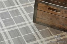 an old wooden box sitting on top of a tiled floor