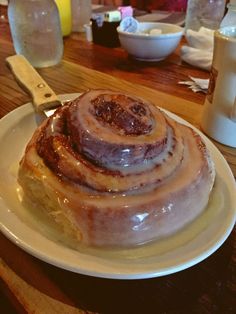 a cinnamon roll sitting on top of a white plate