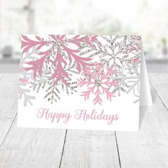 a card with snowflakes on it and the words happy holidays written in purple