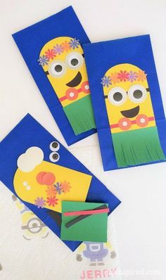 three blue envelopes with yellow and green paper cut out to look like minion