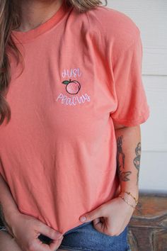 My absolute favorite tee! This 'just peachy ' tee is embroidered on a Comfort Colors short sleeve unisex tee.  Please wash on gentle cycle and dry on low.  If you are wanting a different design, wording, or a different clothing style, please send me a message so we can discuss the details. Please include thread color at checkout If you need this order rushed, please add these to your cart: https://www.etsy.com/listing/1043569716/rush-my-order-for-t-shirts?ref=shop_home_active_19&frs=1 Rush my order + Priority shipping, click here: https://www.etsy.com/listing/1043567696/rush-my-order-priority-shipping-for-t?ref=shop_home_active_35&frs=1 Cute Peach T-shirt With Crew Neck, Spring Peach Crew Neck T-shirt, Heather Peach Short Sleeve Cotton T-shirt, Heather Peach Cotton Short Sleeve T-shirt, Peach Relaxed Fit Crew Neck T-shirt, Heather Peach Cotton T-shirt, Summer T-shirt With Letter Embroidery And Short Sleeves, Summer Short Sleeve T-shirt With Letter Embroidery, Pink T-shirt With Embroidered Graphics And Relaxed Fit