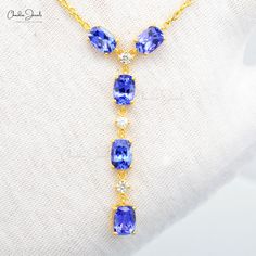 Description Add a touch of luxury to your look with our genuine tanzanite and delicate diamond lariat necklace. Crafted with care in 14k yellow gold, this necklace highlights mini stones of tanzanite and diamond secured with prong setting. Product Details SKU CJ N 1970 TZ YG NW Metal 14K Solid Yellow Gold Chain type Cable Chain Chain length 16 inch Closing mechanism Spring Ring Product dimension - Birthstone December Certification - Tanzanite Details Size 7x5mm Quality AAA Pieces 5 Weight 5.02 S Gold Light Weight Necklace, Diamond Lariat Necklace, Light Weight Necklace, Tanzanite Diamond, Gold Light, Yellow Gold Chain, Lariat Necklace, Cable Chain, Spring Rings