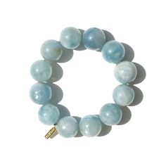 Aquamarine Bracelet by Marne Aquamarine, with its soft blue-green tones reminiscent of calm ocean waves, is the highlight of this Marne bracelet. Featuring 12 natural aquamarine stones, each with subtle color variations, this bracelet is completed with a 22K gold-plated Marne tag and an elastic fit for versatile, easy wear. Key Features: 12 Aquamarine gemstones, each 16mm/0.62 inch 22K Gold plated Marne tag Elastic fit for comfortable wear Bracelet length: 19.2cm/7.56 inch in total Gift Ideas an Blue Aquamarine Bracelets With Natural Stones, Blue Aquamarine Bracelet For Gift, Blue Aquamarine Bracelets For Gift, Elegant Blue Aquamarine Bracelets, Blue Aquamarine Natural Stone Bracelets, Calm Ocean, Color Key, Aquamarine Bracelet, Forever Jewelry