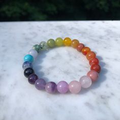 Introducing our exquisite handmade Rainbow Chakra 🌈Gemstone bracelet. This stunning design features a combination of: ❤️Red Jasper, Banded Carnelian, Red Aventurine 🧡Orange dyed Chalcedony, Goldstone 💛Yellow Aventurine, Yellow Jade, Lemon Jade  💚Green Jade, Prehnite, Green Spot Jasper 💙Aquamarine, Blue Magnesite, Blue Goldstone  💜Amethyst, Lavendar Chalcedony, Lepidolite Kunzite, Rose Quartz, and Rhodonite Beads are approximately 8mm each but vary a little in size. Bracelet is with a non-e Multicolor Polished Beads Crystal Bracelet For Gift, Gift Multicolor Polished Beads Crystal Bracelet, Spiritual Beaded Bracelets With Polished Beads, Spiritual Round Beaded Bracelets With Polished Beads, Crystal Bracelet With Gemstone Beads As A Gift, Spiritual Crystal Bracelet With Gemstone Beads, 8mm Round Beads Crystals For Jewelry Making, Gemstone Round Beads Crystals As Gifts, Gift Crystal Bracelet With Gemstone Beads