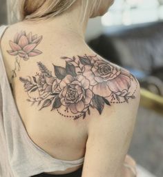 a woman with a flower tattoo on her shoulder