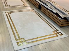 a white rug with gold trim on the floor