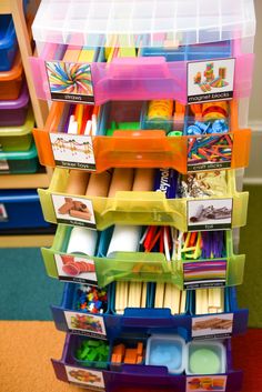 a stack of plastic containers filled with lots of crafting supplies