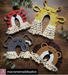 four different colors of rope on top of a wooden table next to leaves and flowers