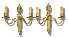 a set of four wall sconces with candles