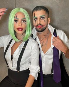 a man and woman dressed up as clowns pose for the camera with makeup on their faces