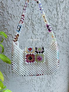 The Granny Square Pearl Bead Bag is completely handmade. I design with natural beads and lovingly. This size is perfect for carrying your keys, cards and wallet. I can produce bags according to your request. Detail Handmade product, Only produced in 1 day, Suitable for daily use I send my cargo free of charge by express shipping. Canada: 3-7 business days United States: 3-7 business days North America: 3-7 business days Europe: 3-7 business days • Materials Crystal beads, Pearl Beads Everyday White Beaded Shoulder Bag, White Beaded Rectangular Shoulder Bag, White Round Beaded Necklaces For Everyday, White Beaded Bohemian Shoulder Bag, White Beaded Square Shoulder Bag, Everyday Beaded Necklaces With Round Beads, Bead Bag, Square Crystal, Granny Square Bag