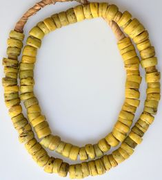 Smaller sized antique yellow Hebron Beads. Some chips and pitting on these old beads. Multiple strands available, all similar to the one pictured. Length of strand: 24 inches including raffia, ~21 inches of beads; Average Diameter size: 10-12mm Date: 1800's These were collected by us in the 1970s - 1980s. Antique Round Spacer Beads, Yellow Wooden Beaded Necklaces For Beach, Yellow Wooden Beads Necklace For Beach, Yellow Wooden Beads For Beach, Vintage Beaded Necklaces With Round Beads For Beach, Vintage Beaded Necklace With Round Beads For Beach, Yellow Round Beaded Spiritual Necklace, Vintage Wooden Round Beads, Traditional Yellow Beaded Necklace For Beach