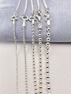 Welcome to our store! Discover the elegance of our 925 STERLING SILVER BALL BEADED CHAIN NECKLACE, a versatile and stylish piece perfect for both men and women. Whether you're looking for a choker chain for a pendant or a long chain to wear on its own, this silver ball necklace is the ideal choice. Handcrafted with care, this necklace is available in various sizes to suit your style and occasion. PRODUCT HIGHLIGHTS: PREMIUM QUALITY: Made from genuine 925 sterling silver, this ball beaded chain i Silver Round Beads Chain Necklace Gift, Silver Jewelry With Ball Chain For Gift, Silver Chain Necklace With Round Beads For Gift, Silver Beads Chain Necklace Gift, Sterling Silver White Gold Ball Chain Jewelry, Sterling Silver Jewelry With Ball Chain In White Gold, Sterling Silver Jewelry With White Gold Ball Chain, Silver Chain Necklace With Lobster Clasp And Round Beads, Silver Jewelry With Ball Chain And Round Beads