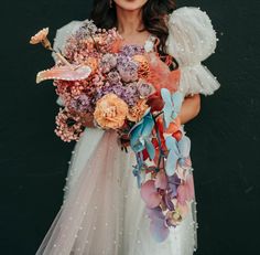 a woman holding a bouquet of flowers in her hands