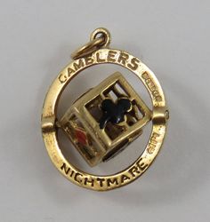 "This is a vintage \"Gamblers Nightmare Die With Enamel Suits\" 9 karat gold charm for a charm bracelet. There is a 3D die inside a circle, it has two enamel pairs of dice, black enamel spade and club and a red enamel diamond and heart. It weighs 2.05 grams and measures 5/8\" x 3/4\", marked 9, 375\" All charms come with a split ring to attach to a bracelet. We have hundreds of charms in stock. If you don't see what you are looking for in our shop please contact us as it is likely we have it. In Antique Good Luck Charms Jewelry, Antique Gold Charms For Collectors, Antique Brass Charms For Collectors, Vintage 14k Gold Engraved Charms, Vintage Engraved 14k Gold Charms, Vintage 14k Gold Charms For Gift, Vintage 14k Stamped Charms As Gift, Vintage 14k Stamped Charms For Gift, Vintage Engraved Jewelry For Good Luck