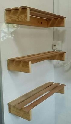 two wooden shelves are attached to the wall