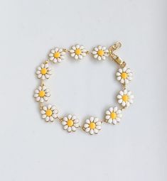 "Daisy Bracelet. This is made out of a gold-filled daisy chain and hardware. This unique and bold bracelet will catch the eye and is a unique accessory to complete any outfit! Wear it alone, or stack with multiple bracelets. It is handmade with high-quality materials that will last. All of our bracelets can be made for infant, toddlers, girls, teens, and women! Due to the design of this bracelet, it may run a bit big. If you have any questions please send me a message. PLEASE READ SIZING DETAILS Baby Bracelet Gold, Toddler Bracelet, Multiple Bracelets, Daisy Jewelry, Teen Jewelry, Spring Bracelet, Daisy Bracelet, Trendy Bracelets, Baby Bracelet