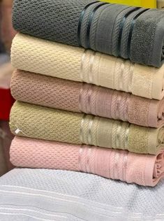 towels stacked on top of each other in different colors