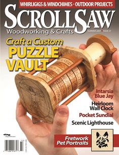 the cover of woodworking & crafts magazine features a hand holding a wooden puzzle piece