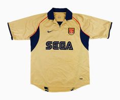 a yellow soccer jersey with the word sega on it's chest and two blue stripes