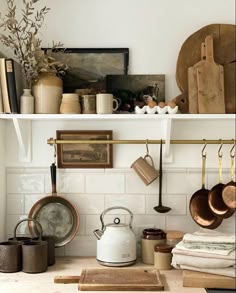 pots and pans are hanging on the wall