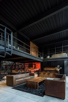 a living room filled with furniture next to a staircase