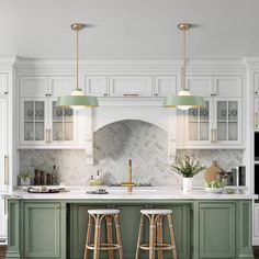 two bar stools are in front of the kitchen island