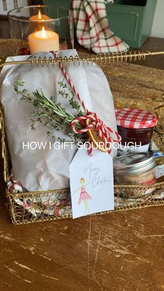 a christmas gift basket with candles and cards