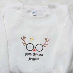 Merry Christmas Muggle Harry Potter Reindeer Embroidered Shirt, Christmas Embroidered Hoodie, Best Christmas Gifts For Family Welcome to the enchanting realm of Tinicloset, where the magic of custom embroidery and the wonder of your favorite movies collide to create a unique collection of apparel that will leave you spellbound. Our store is a treasure trove of creativity, offering an array of custom embroidered shirts, sweatshirts, T-shirts, and hoodies that will make your wardrobe a canvas of f Harry Potter Christmas Shirt, Family Hoodie, Best Family Gifts, Reindeer Shirt, Minnie Mouse Christmas, Embroidered Shirts, Family Christmas Gifts, Reindeer Christmas, Shirt Embroidery