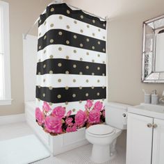 a pink and black shower curtain in a bathroom