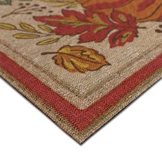 an area rug with flowers and leaves on the bottom, in red, orange, yellow and green colors