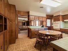 a large kitchen with wooden cabinets and an island