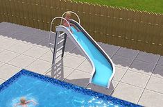 a pool with a slide next to it and a person swimming in the water below