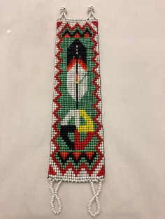 Bracelet in Guatemalan glass beadwor approximately 7” long x 2” wide. This design is a copy of a Native North American design, made by Native Guatemalans. This beadwork is done in the homes of Indigenous Artists living in the highlands of Guatemala in Central America. This design is a copy of a Native North American design, made by Native Guatemalans.  This beadwork is done in the homes of Indigenous Artists living in the highlands of Guatemala in Central America. eBay integration by White Southwestern Beaded Bracelet, White Beaded Southwestern Bracelet, Traditional Handmade Rectangular Beads, Traditional Green Beaded Bracelets, Bohemian White Rectangular Bracelets, Bohemian White Rectangular Bracelet, White Bohemian Rectangular Bracelet, Loom Designs, Native Artwork