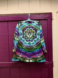 This is an ultra soft tunic with a cute flared hem.  It was made and ice dyed here in my shop.  This fleece has spandex, is midweight, and its stretchy so the measurements above are the minimum measurements.  This was ice dyed using a set of "alien colors" and I love how they all harmonize.  What type of animal do you see on the back?  This garment has been washed and dried on hot settings a lot of times during the dye process so will not shrink or fade in your care provided you avoid bleach. Bohemian Hand Dyed Long Sleeve Tops, Tie Dye Long Sleeve Tops For Festival, Fitted Multicolor Long Sleeve Tunic, Multicolor Fitted Long Sleeve Tunic, Ice Tie Dye, Ice Dyeing, Back Neck, Womens Tunics, Tie Dyed