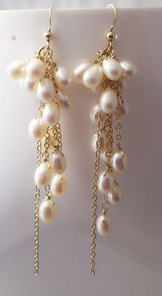 Creamy White Freshwater Butterfly Pearls are suspended and cascade down a fancy 14k gold-filled ear hooks and chains with pearls that are iridescent creamy white. These earrings measure approximately 3 inches in length from ear hooks. Gold Dangle Pearl Earrings With High Luster, Gold High Luster Dangle Pearl Earrings, High Luster Gold Dangle Pearl Earrings, Pearl White Dangle Chandelier Earrings With Pearl Drop, White Pearl Chain Earrings For Celebration, Pearl Drop Chandelier Earrings, Pearl White Dangling Bead Earrings, Yellow Gold Pearl Drop Dangle Bridal Earrings, Pearl White Dangle Earrings With Beads