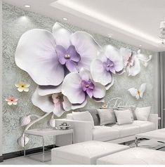 the living room is decorated with white furniture and large purple flowers on the wall behind it