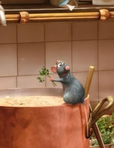 a cartoon mouse sitting on top of a large pot filled with dirt next to utensils