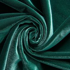 a close up shot of the green velvet fabric that is very soft and shiny,