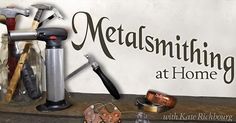 there are many tools on the table and in front of this sign that says metal smithing at home