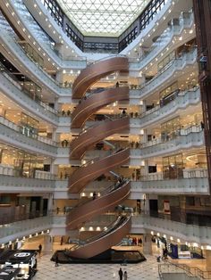 a spiral staircase in the middle of a large building