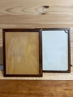 an open wooden box with a mirror on top of it and wood planks in the background