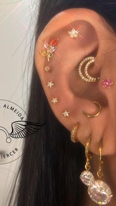 the ear is decorated with different types of piercings